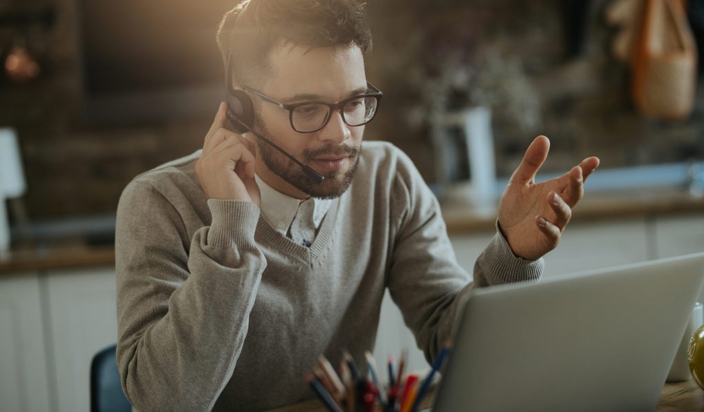 young-entrepreneur-having-conference-call-computer-while-working-home-1.jpg